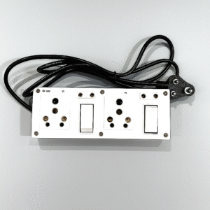 White power extension board with three universal sockets, two switches, and a black 3-pin plug with cord placed on a grey background.