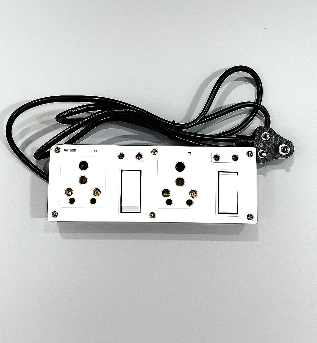 White power extension board with three universal sockets, two switches, and a black 3-pin plug with cord placed on a grey background.